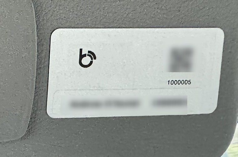 Close view of an enrolled BluSignal label, showing the mark and the serial